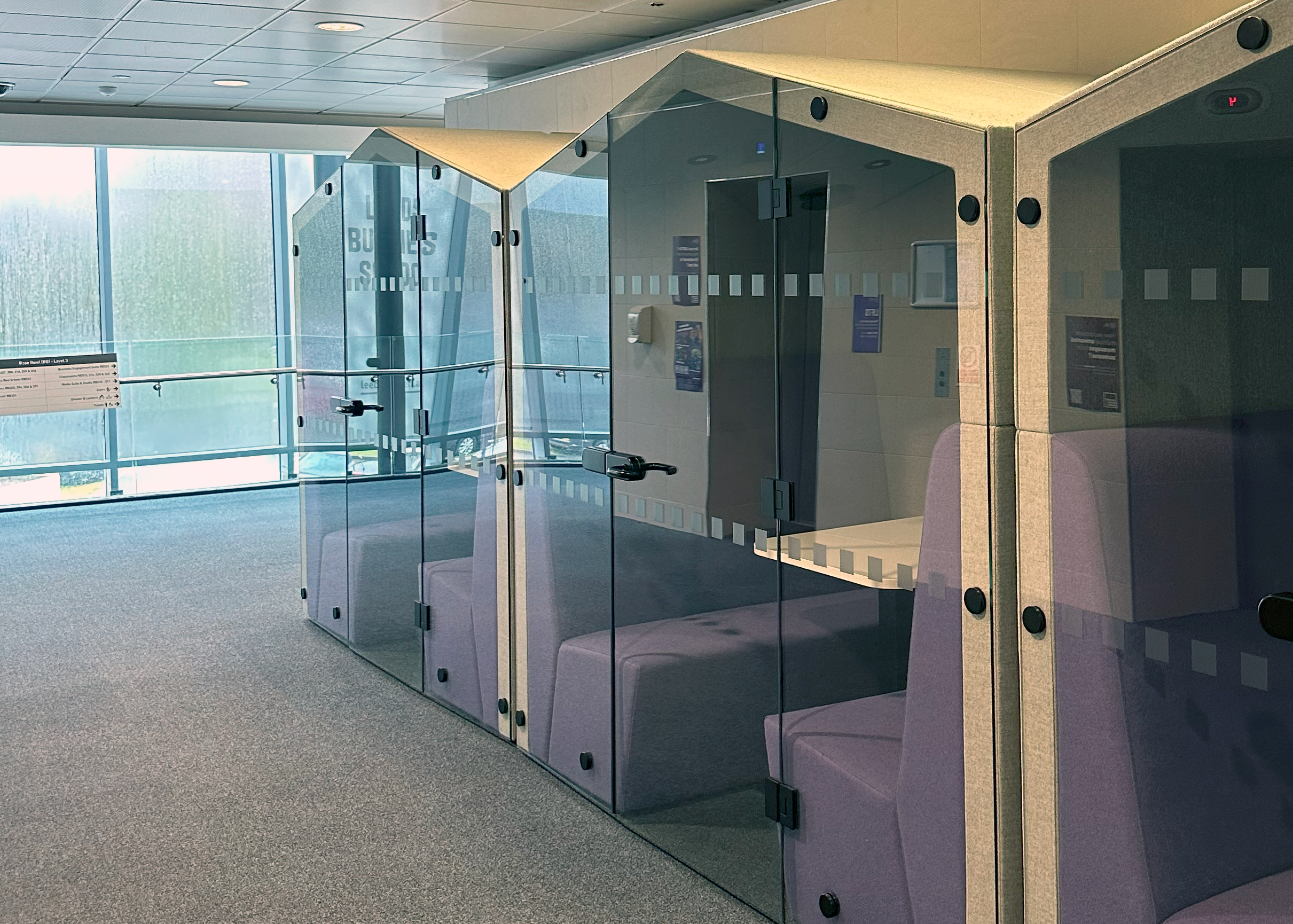 Row of meeting pods with purple benches